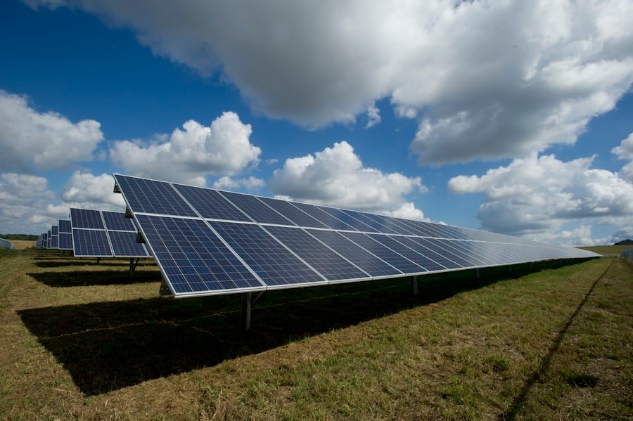Distesa di pannelli fotovoltaici sotto un cielo con nuvole